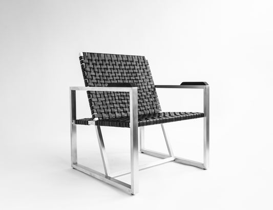 A contemporary lounge chair with a minimalist metal frame and black woven seating, designed for outdoor use.